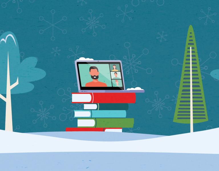 A snowfield, with alternating style of trees. In the middle is a stack of books with a laptop on the top.