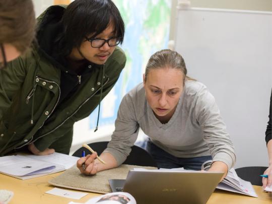 Faculty member and student looking at a computer screen